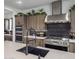 Contemporary kitchen featuring a gas range and custom cabinetry at 22034 N 59Th Pl, Phoenix, AZ 85054