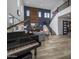 Elegant living room with high ceilings, grand piano, and modern fireplace at 22034 N 59Th Pl, Phoenix, AZ 85054