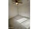 Comfortable carpeted bedroom featuring ample closet space and a ceiling fan at 22233 N 76Th Dr, Peoria, AZ 85383