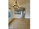 Dining room with tile flooring, a chandelier, and a view into the living areas at 22233 N 76Th Dr, Peoria, AZ 85383