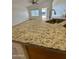 Granite countertop kitchen island with sink and stainless steel dishwasher at 22233 N 76Th Dr, Peoria, AZ 85383