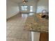 View of a kitchen with granite countertops and tile flooring adjoining a Gathering room at 22233 N 76Th Dr, Peoria, AZ 85383