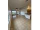 Kitchen with granite countertops, tile flooring, and modern appliances adjacent to Gathering room at 22233 N 76Th Dr, Peoria, AZ 85383