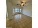 Spacious living room with tiled flooring, a ceiling fan, and a bright bay window overlooking the backyard at 22233 N 76Th Dr, Peoria, AZ 85383