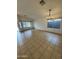 Bright living room features tile flooring, chandelier, and natural light from large windows at 22233 N 76Th Dr, Peoria, AZ 85383