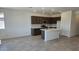 Open kitchen with stainless steel appliances, an island, white quartz countertops, and dark wood cabinets at 22319 W Monona Ln, Surprise, AZ 85387