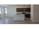 Open kitchen with stainless steel appliances, an island, white quartz countertops, and dark wood cabinets at 22319 W Monona Ln, Surprise, AZ 85387
