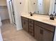 Bathroom features a double sink vanity, sleek countertops, and a glass-enclosed shower at 22327 W Monona Ln, Surprise, AZ 85387