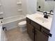 Bathroom features a white tub, toilet, sleek countertop, and modern fixtures and design at 22327 W Monona Ln, Surprise, AZ 85387