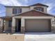 Two-story home with a two car garage, covered porch, and attractive architectural details at 22327 W Monona Ln, Surprise, AZ 85387