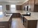 Modern kitchen with an island, stainless steel appliances, and sleek countertops and cabinetry at 22327 W Monona Ln, Surprise, AZ 85387
