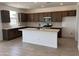 Spacious kitchen features an island, stainless steel appliances, and attractive cabinetry and countertops at 22327 W Monona Ln, Surprise, AZ 85387
