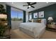 Spacious bedroom with large windows and a ceiling fan at 22343 W Monona Ln, Surprise, AZ 85387