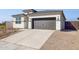 New construction home with a modern design and driveway at 25350 W Sunland Ave, Buckeye, AZ 85326