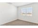 Well-lit bedroom with window and neutral carpeting at 25359 W Sunland Ave, Buckeye, AZ 85326