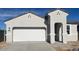 New single-story home with a two-car garage and neutral color scheme at 25412 W Sunland Ave, Buckeye, AZ 85326