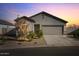 Single story home with landscaping, two-car garage, and desert setting at 25587 N Boreas Rd, Florence, AZ 85132