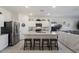 Modern kitchen with white cabinets, granite island, and stainless steel appliances at 25587 N Boreas Rd, Florence, AZ 85132