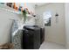 Laundry room with washer, dryer, and shelving at 25587 N Boreas Rd, Florence, AZ 85132