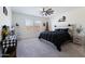 Main bedroom with king-size bed, ceiling fan, and large windows at 25587 N Boreas Rd, Florence, AZ 85132