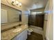 Bathroom boasts granite vanity, tub and shower combo, and tile floors at 25603 W Hedgehog Rd, Wittmann, AZ 85361