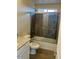 Bathroom with tub, shower, granite vanity, and wood-look tile floor at 25603 W Hedgehog Rd, Wittmann, AZ 85361