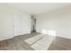 Bedroom with wood-look tile floors and a closet with sliding doors, offering ample storage space at 25603 W Hedgehog Rd, Wittmann, AZ 85361