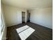 Bright bedroom featuring wood-look floors and a double door closet at 25603 W Hedgehog Rd, Wittmann, AZ 85361