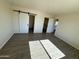 Bedroom with tile floors and large window at 25603 W Hedgehog Rd, Wittmann, AZ 85361