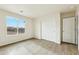 Bedroom featuring wood-look tile flooring, closet with sliding doors and a window overlooking the desert landscape at 25603 W Hedgehog Rd, Wittmann, AZ 85361