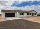 New single-story home with attached garage, neutral exterior, and desert landscaping at 25603 W Hedgehog Rd, Wittmann, AZ 85361