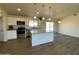 Island kitchen with granite countertops, stainless steel appliances, and view of backyard at 25603 W Hedgehog Rd, Wittmann, AZ 85361