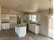 Kitchen with island, granite countertops, and white cabinets at 25603 W Hedgehog Rd, Wittmann, AZ 85361