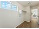 Laundry room with a window and overhead storage, tiled floors, and utility connections at 25603 W Hedgehog Rd, Wittmann, AZ 85361