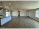 Open concept living room and kitchen with wood-look tile flooring at 25603 W Hedgehog Rd, Wittmann, AZ 85361