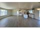 Open living space with kitchen, large windows and wood-look tile floors at 25603 W Hedgehog Rd, Wittmann, AZ 85361