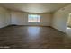 Spacious living room with tile floors and large window offering scenic views at 25603 W Hedgehog Rd, Wittmann, AZ 85361