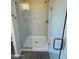 Large walk-in shower with marble-style tile and glass enclosure at 25603 W Hedgehog Rd, Wittmann, AZ 85361