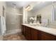 Bathroom with double sinks, shower, and tiled floor at 26637 W Irma Ln, Buckeye, AZ 85396