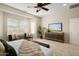 Bedroom with TV, dresser, and large window at 26637 W Irma Ln, Buckeye, AZ 85396