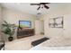 Bedroom with TV, dresser, and large window at 26637 W Irma Ln, Buckeye, AZ 85396