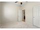 Spacious bedroom with door to bathroom and carpet flooring at 26637 W Irma Ln, Buckeye, AZ 85396