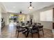 Bright dining area with glass table, modern chairs, and view to backyard at 26637 W Irma Ln, Buckeye, AZ 85396