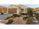 Single-story home with desert landscaping and a two-car garage at 26637 W Irma Ln, Buckeye, AZ 85396