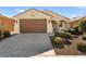 Front view of a charming house with a brown garage door at 26637 W Irma Ln, Buckeye, AZ 85396