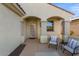 Covered entryway with two comfy chairs and a small table at 26637 W Irma Ln, Buckeye, AZ 85396