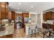 Island kitchen with granite countertops and dark wood cabinets at 26637 W Irma Ln, Buckeye, AZ 85396