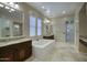 Elegant bathroom with double vanity, soaking tub, and walk-in shower at 28548 N 68Th Ave, Peoria, AZ 85383