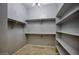 Large walk-in closet with shelves and hanging rods at 28548 N 68Th Ave, Peoria, AZ 85383