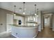 Modern kitchen with white cabinets and granite island at 28548 N 68Th Ave, Peoria, AZ 85383